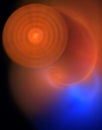 Circles and discs in bright orange over blue enlightened haziness. Royalty Free Stock Photo