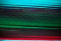 Abstract colorful parallel lines texture background, blue, green, red neon light strips on black backdrop, decorative bright dots Royalty Free Stock Photo