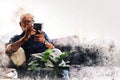 Senior man sitting and playing mobile phone app at home on watercolor illustration painting background. Royalty Free Stock Photo