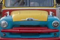 Abstract colorful shape on the metallic wall of an old bus