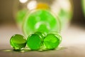 Abstract composition with beautiful, green, transparent, round jelly balls on an aluminium foil with reflexions