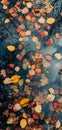 An abstract composition of colorful autumn leaves floating on a reflective water surface of a pond Royalty Free Stock Photo