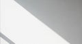 Abstract composition with diagonal shadow across a textured white surface. The light creates a Royalty Free Stock Photo
