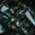 Abstract composition featuring a complex array of fragmented, reflective surfaces,