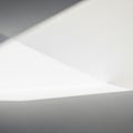 Abstract composition of light and shadow on white surfaces, creating geometric shap Royalty Free Stock Photo