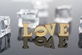 Abstract composition of love. Isolated wooden letters and glass balls Royalty Free Stock Photo