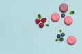 Abstract composition of macaroons, raspberries, blueberries