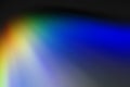 Abstract composition of radial red, yellow, green, blue rays on a shadowy gray background