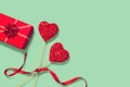 Abstract composition with two decorative hearts and red present box on colorful background. Valentine day theme Royalty Free Stock Photo