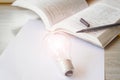 Abstract concept Study and educational equipment. Light bulb and book.learning to be smart. Royalty Free Stock Photo
