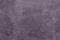 Abstract concrete background of a beautiful dark lilac shade. Photo with a texture of uneven plaster