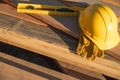 Abstract of Construction Hard Hat, Gloves and Level Resting on W Royalty Free Stock Photo