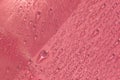 Abstract cosmetic background of a drop of moisturizing liquid on a pink background. Moisturizer tonic, lotion, serum.