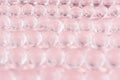 Abstract cosmetic background -  glass balls on pastel pink backdrop. Royalty Free Stock Photo