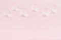 Abstract cosmetic background -  glass nucleuses on pastel pink backdrop, copy space. Royalty Free Stock Photo