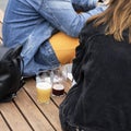 Abstract couple, a guy and a girl sitting drinking fresh dark and light beer Royalty Free Stock Photo