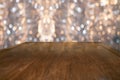 Abstract Creative Christmas blurred background with empty wood table in front of beautiful bokeh. Royalty Free Stock Photo