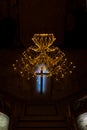 Abstract cross in church on black cement background