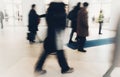 Abstract crowd of anonymous blurred people walking in shopping mall