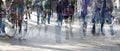 Abstract crowd of people walking without social distance on a shopping street in the city, multiple exposure and motion blur,