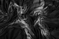 Abstract crumpled darkened black fabric texture background