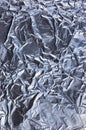 Abstract crumpled textured silver aluminum foil, large detailed vertical background closeup texture pattern in blue Royalty Free Stock Photo