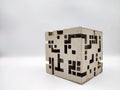 Abstract cube with random square holes pattern made out of cardboard Royalty Free Stock Photo
