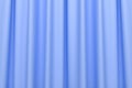 Abstract curtain of blue color with wavy folds. 3D render