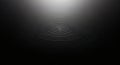 Abstract dark background with concentric ripples and a spotlight effect Royalty Free Stock Photo