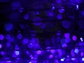 Abstract Dark Bokeh light blurred background, lightbulb on Christmas tree for celebrate season with blue, purple and colorful Royalty Free Stock Photo