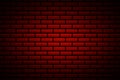 Abstract dark brick wall background illuminated by a spot