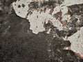 Abstract Dark Grunge wall texture background. Paint cracking off dark wall with rust underneath.distressed crackled texture. Royalty Free Stock Photo