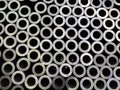 Abstract dark industrial background of sawed steel pipes ends - flat and full frame Royalty Free Stock Photo