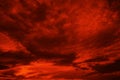 Abstract dark red background. Dramatic red sky. Red sunset with clouds. Fantastic sunset background with copy space for design. Royalty Free Stock Photo