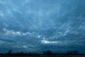 Abstract dark storm clouds over trees, spring evening Royalty Free Stock Photo