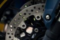 Abstract dark tone beside veiw of Disc Brake of motorcycle. Royalty Free Stock Photo