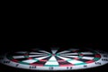 Abstract dartboard on dark background lighted with snoot