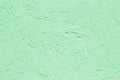 Abstract decorative background light green painted stucco wall texture. Handmade rough art background with copy space for design Royalty Free Stock Photo