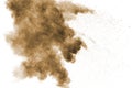 Abstract deep brown dust explosion on white background. Royalty Free Stock Photo