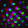Abstract defocus background, colored green red violet purple dot circle on a black background. Illumination blurry lights, Royalty Free Stock Photo