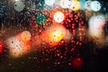 Abstract defocus background, night city lights through wet glass with rain drops, bokeh effect Royalty Free Stock Photo