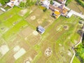 Aerial photo of a house in the middle of a large rice field