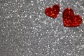 Abstract defocused grey glitter background with two red hearts Royalty Free Stock Photo