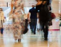 Abstract defocused motion blurred walking young men and women in the shopping center, urban lifestyle concept Royalty Free Stock Photo