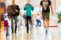 Abstract defocused motion blurred young people walking in the shopping center, urban lifestyle concept, background. Royalty Free Stock Photo