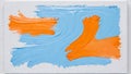 Abstract delicate strokes of orange and pale blue in acrylic or oil paint on white background. Colorful vibrant painting