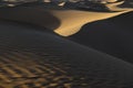Abstract desert sand dunes with deep shadows before sunset