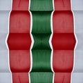 abstract design with cuts of fabric in green, white and red color, background and texture