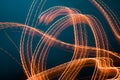 Abstract design of light painting. Orange lights against dark background Royalty Free Stock Photo