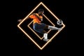 Abstract desing, concept of sport, action, motion in sport. Young african football, soccer player in neon light on black Royalty Free Stock Photo